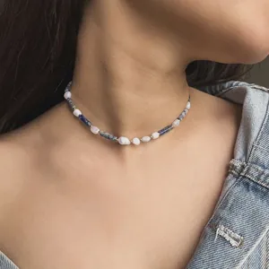 Detailed view of a vintage natural stone beaded choker necklace worn on model's neck