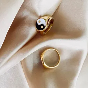 Elegant 18K gold plated stainless steel chunky Yin Yang signet ring on silk background.