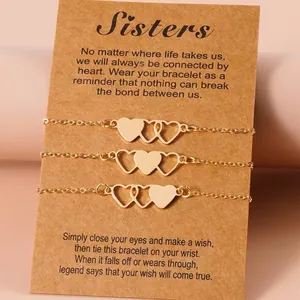 Set of three elegant gold-tone heart chain bracelets for sisters on a sentimental gift card