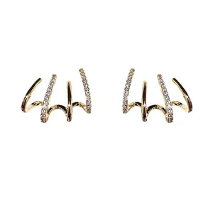 Shining gold-plated four-claw cuff earrings with elegant micro-set zircon stones