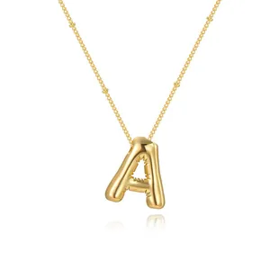 Elegant gold-plated balloon letter A pendant necklace with beaded chain detail.