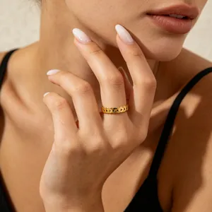 Close-up detail of a gold titanium steel ring with a geometric triangle pattern on finger