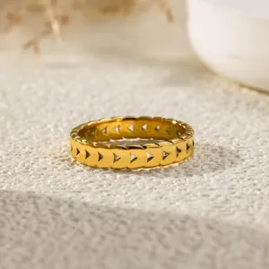 Close-up of a gold-plated titanium steel ring featuring intricate heart-shaped cutouts.