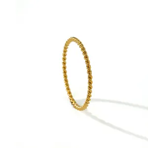 Detailed macro view of a golden twisted rope ring with fine French baroque style texture