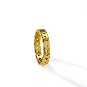 Detailed macro view of a gold titanium steel ring featuring elegant triangular hollow patterns