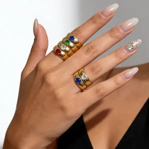 Detailed close-up showing colorful zircon stones on stackable gold titanium steel rings