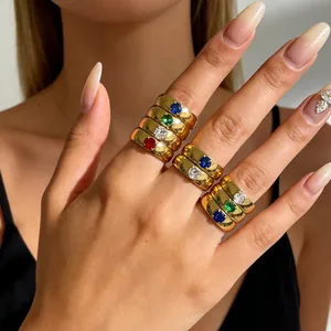 Detailed macro view of gold-plated titanium rings with vibrant colorful zircon stones