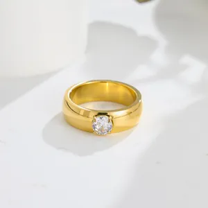 Detail view of a gold-toned titanium steel ring with a sparkling round zircon stone