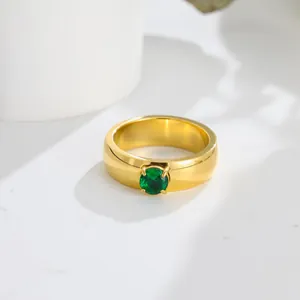 Detailed macro shot of a gold titanium steel ring with a round green zircon