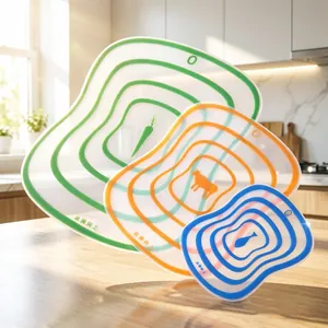 Set of three flexible frosted plastic color-coded cutting boards for kitchen use