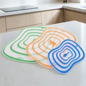 Close-up detail of flexible colorful cutting boards with food icons on a kitchen counter