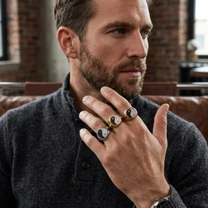 Close-up of three Yin Yang rings with black and white crystals on a male hand