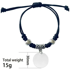 Detail view of a black braided steel bracelet with 30mm round pendant and weight info.