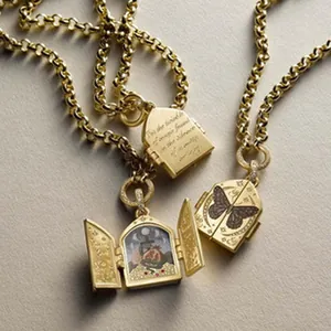 Close-up of vintage tarot locket necklace with 18K gold plating and mystical motifs.