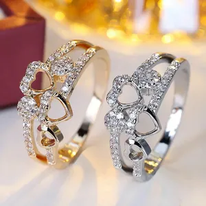 Elegant double-layered copper ring with sparkling zircon hearts in gold and silver