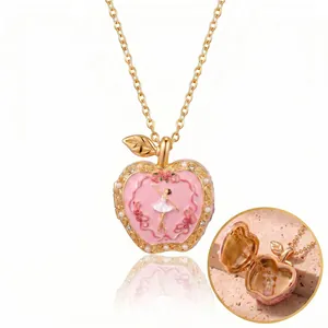Elegant pink enamel apple-shaped locket necklace with ballerina motif and gold plated chain