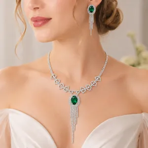 Close-up of elegant emerald green gemstone jewelry set with cascading rhinestone fringe