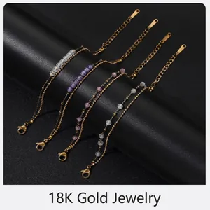 Vista detallada de cuatro pulseras de acero dorado con cuentas de colores