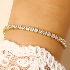 Elegant gold plated tennis bracelet featuring square clear cubic zirconia stones on wrist