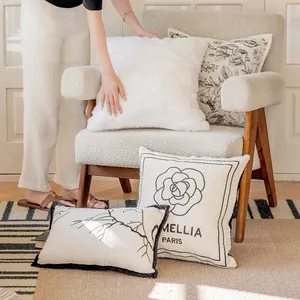 Close-up of elegant French style floral and camellia print cushion covers on a chair