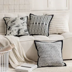 Detail shot of patterned decorative throw pillow covers on a soft cream sofa