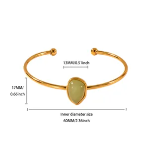 Detailed view of gold-plated cuff bracelet with green stone and dimensions in inches and mm