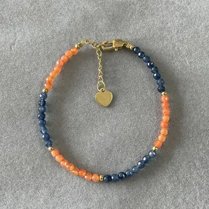 Bohemian beaded bracelet with orange and blue natural stones and a gold heart charm
