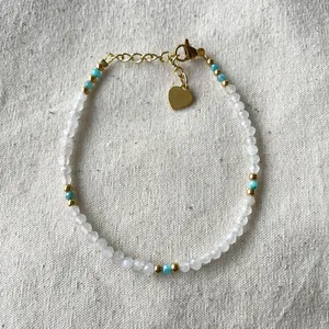 Bohemian natural stone beaded bracelet with clear crystals and a golden heart pendant