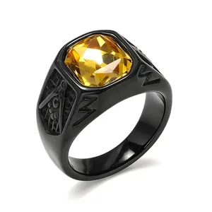 Detailed view of a black titanium steel Freemasonry signet ring with yellow gem