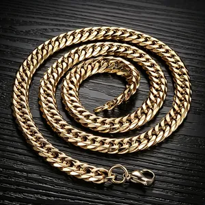 Close-up of golden stainless steel curb link chain on dark textured surface