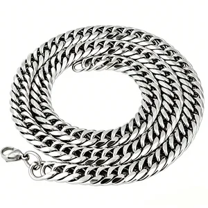 Macro view of a silver stainless steel Cuban link chain with 6-side grinding detail.