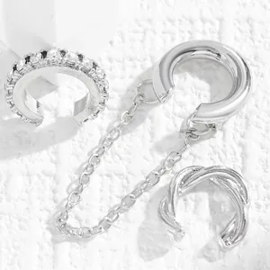 Detailed close-up of three-piece silver-toned ear cuff set with zircon and chain.