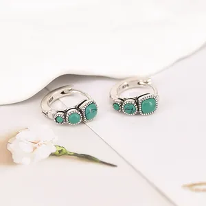 Close-up detail of vintage S925 silver hoop earrings with textured turquoise stones