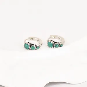 Close-up detail of vintage S925 silver hoop earrings featuring green turquoise stones