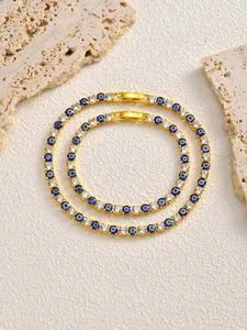 Detailed view of gold plated hip-hop bracelets with evil eye and sparkling zircons