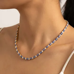 Close-up view of a gold-plated evil eye necklace featuring shimmering zircons on a neck