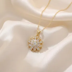 Detailed macro view of a gold-plated rotatable flower pendant necklace with zircons