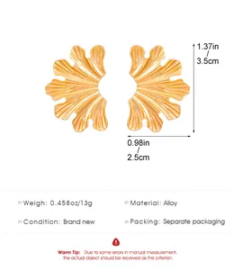 Close-up of gold-tone leaf earrings with dimensions, weight, and material details.
