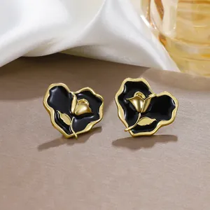Vintage heart-shaped rose stud earrings with black enamel and gold finish