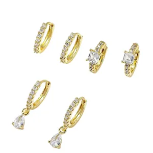 Set of 3 pairs of gold-plated huggie earrings with cubic zirconia drops and stones.