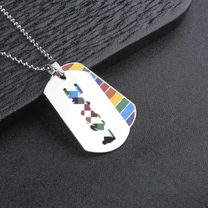 Macro detail of a stainless steel dog tag necklace featuring vibrant rainbow pride stripes