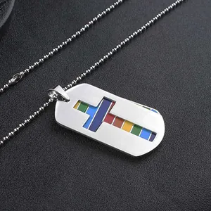 Detailed view of stainless steel dog tag necklace with a rainbow cross cutout design