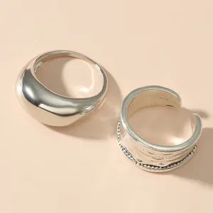 Close-up of minimalist silver rings showing polished and textured details