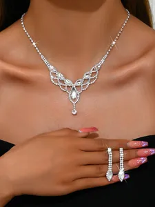 Elegant silver-tone crystal teardrop necklace and earring set worn by a fashion model