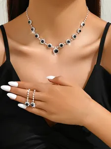 Detailed close-up of a sparkling crystal necklace and matching earrings worn by a model