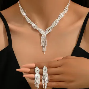 Detailed view of an elegant crystal tassel necklace and matching fringe earrings on a model