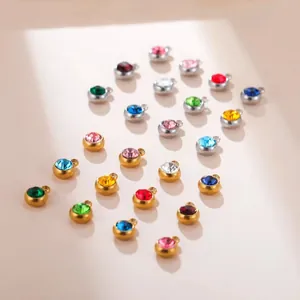 Detail view of various colorful round zircon pendants with gold and silver steel frames