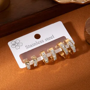 Detailed view of three pairs of gold stainless steel hoop earrings with sparkling zirconia