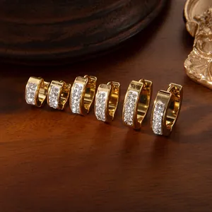 Detailed view of three pairs of gold-plated titanium steel hoop earrings with cubic zirconia