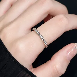 Primo piano di un elegante anello a treccia in argento con cristalli sul dito, lusso